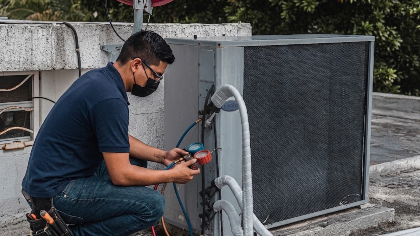 HVAC technician servicing a rooftop condenser unit